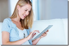 Smiling woman using tablet PC