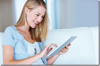 Smiling woman using tablet PC